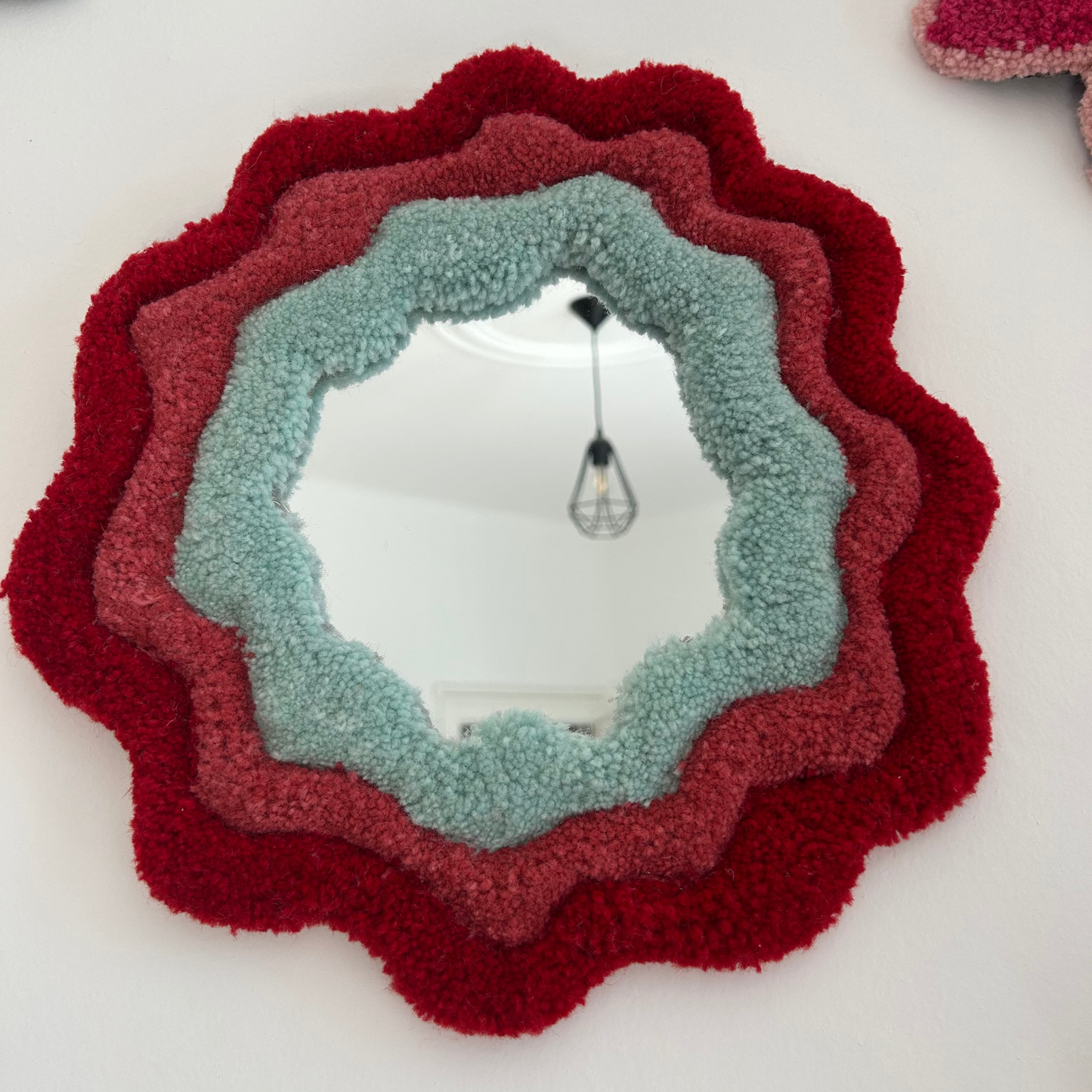 Miroir rouge et vert d'eau en tufting.